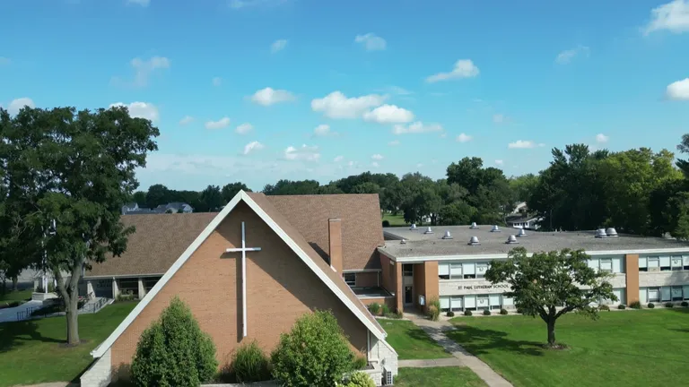 The front of the church on the St. Paul campus, with the steeple, cross, and entrance.